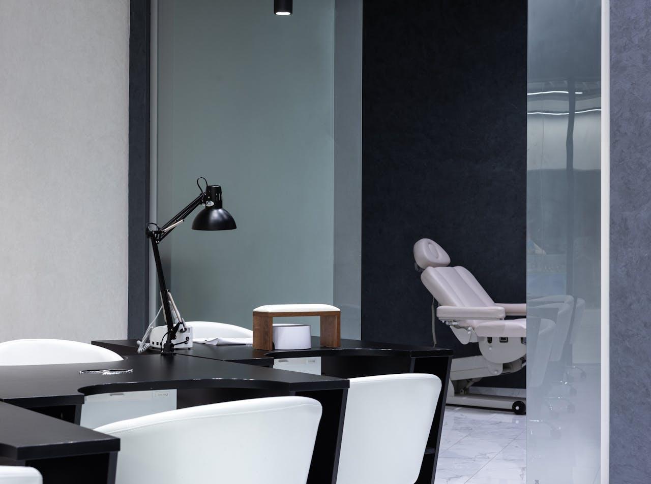 Sleek modern nail salon interior with stylish design and treatment station.